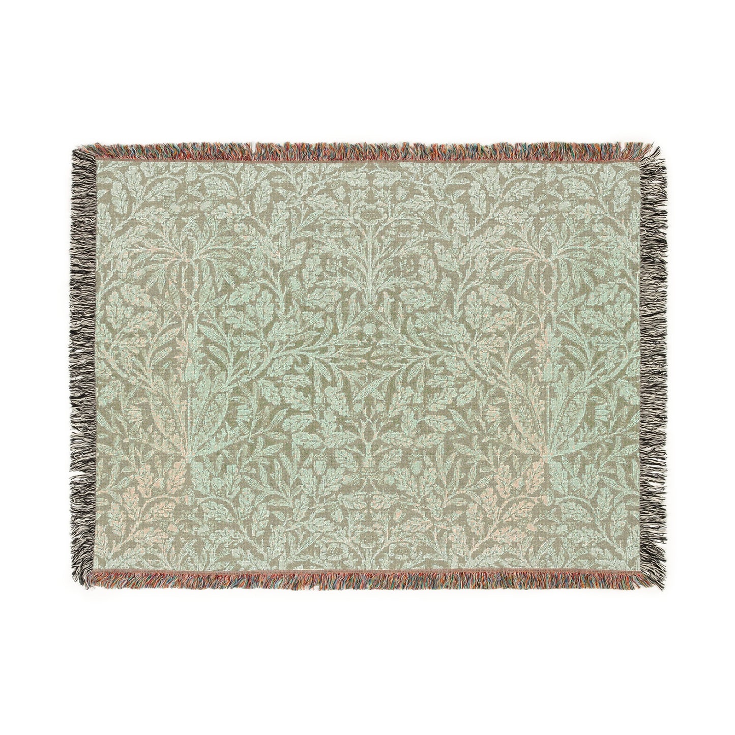 A green woven blanket with a floral pattern and colorful fringed edges displayed on a plain background.