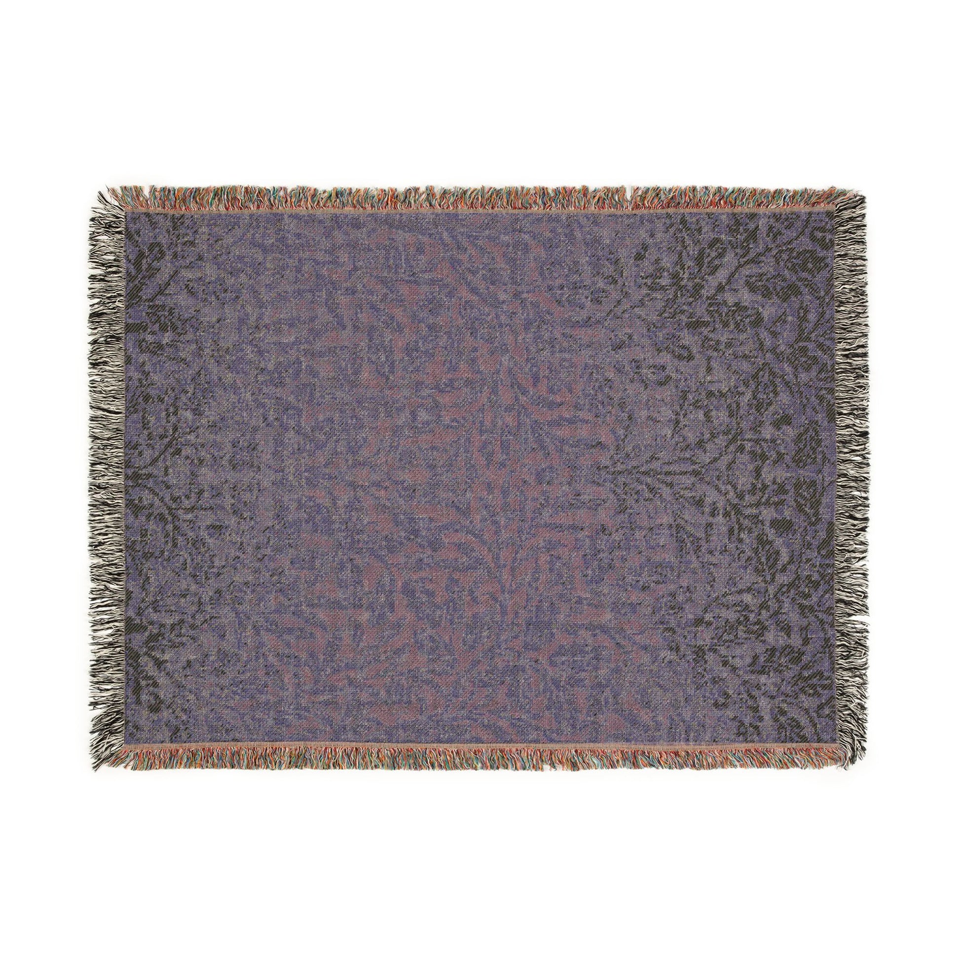 Patterned throw blanket with fringe on a white background