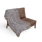 Brown chair with a patterned gray blanket draped over it on a white background