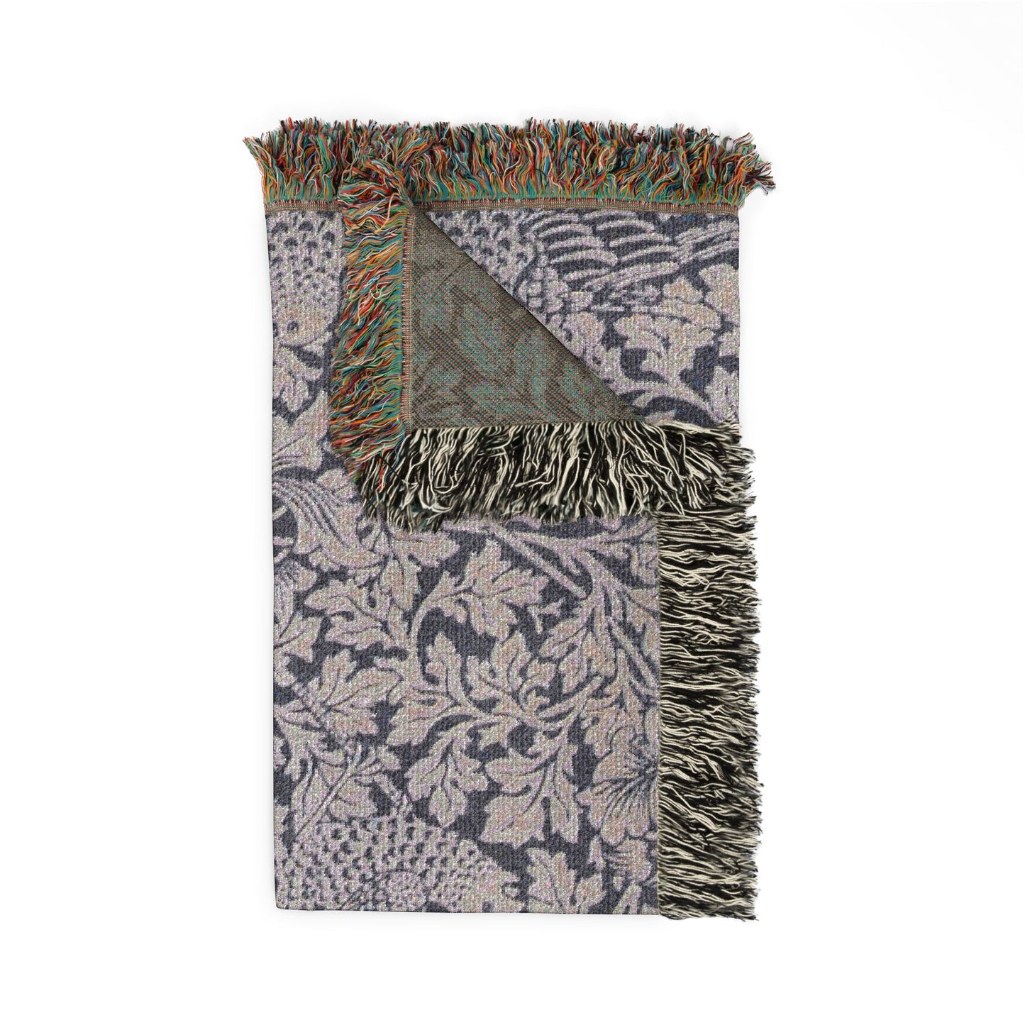 Patterned throw blanket with fringes on a white background