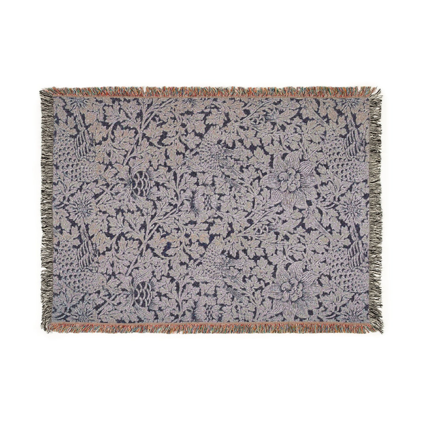 Floral patterned throw blanket with fringe on a white background