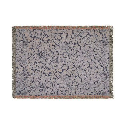 Floral patterned throw blanket with fringe on a white background