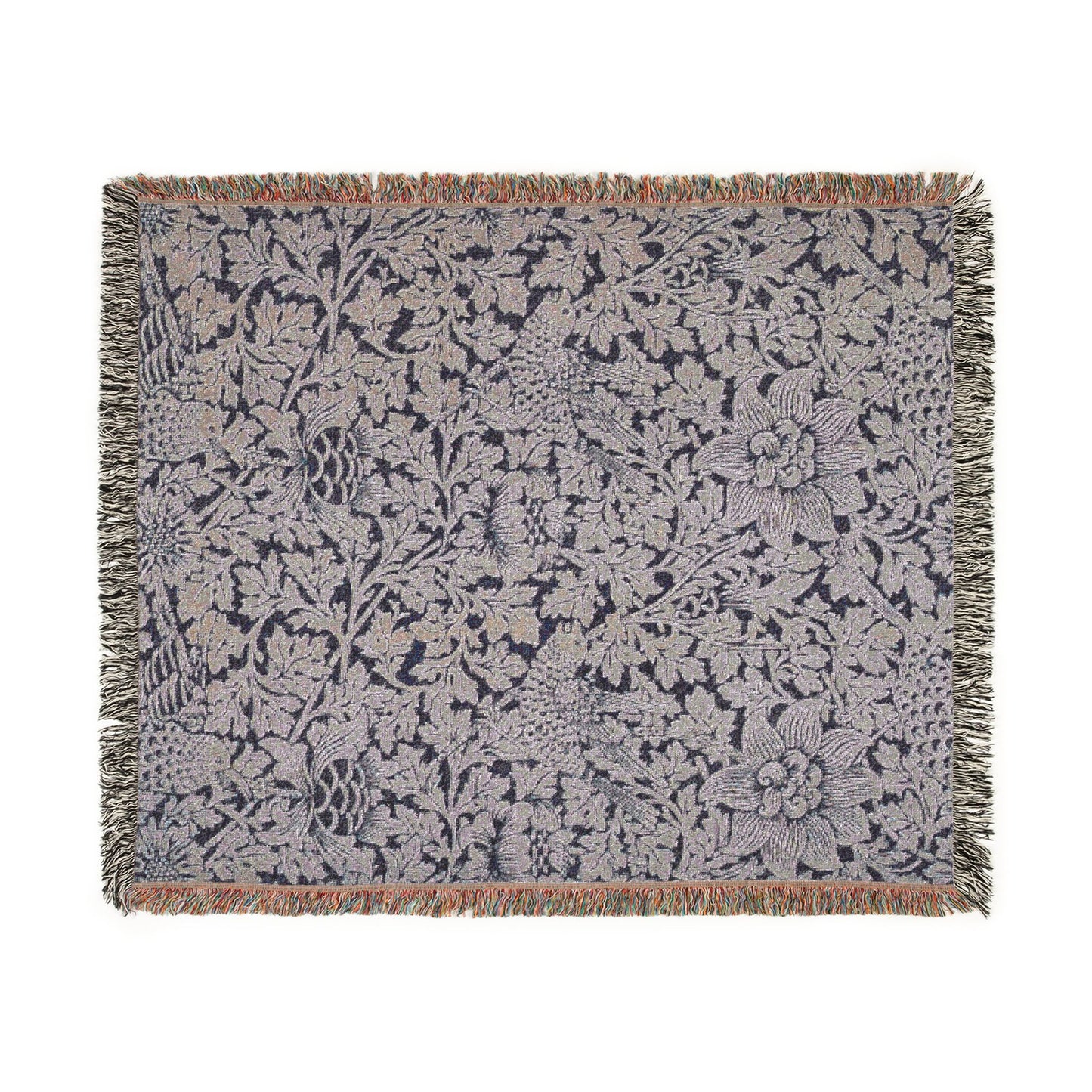 Floral patterned throw blanket with fringe on a white background
