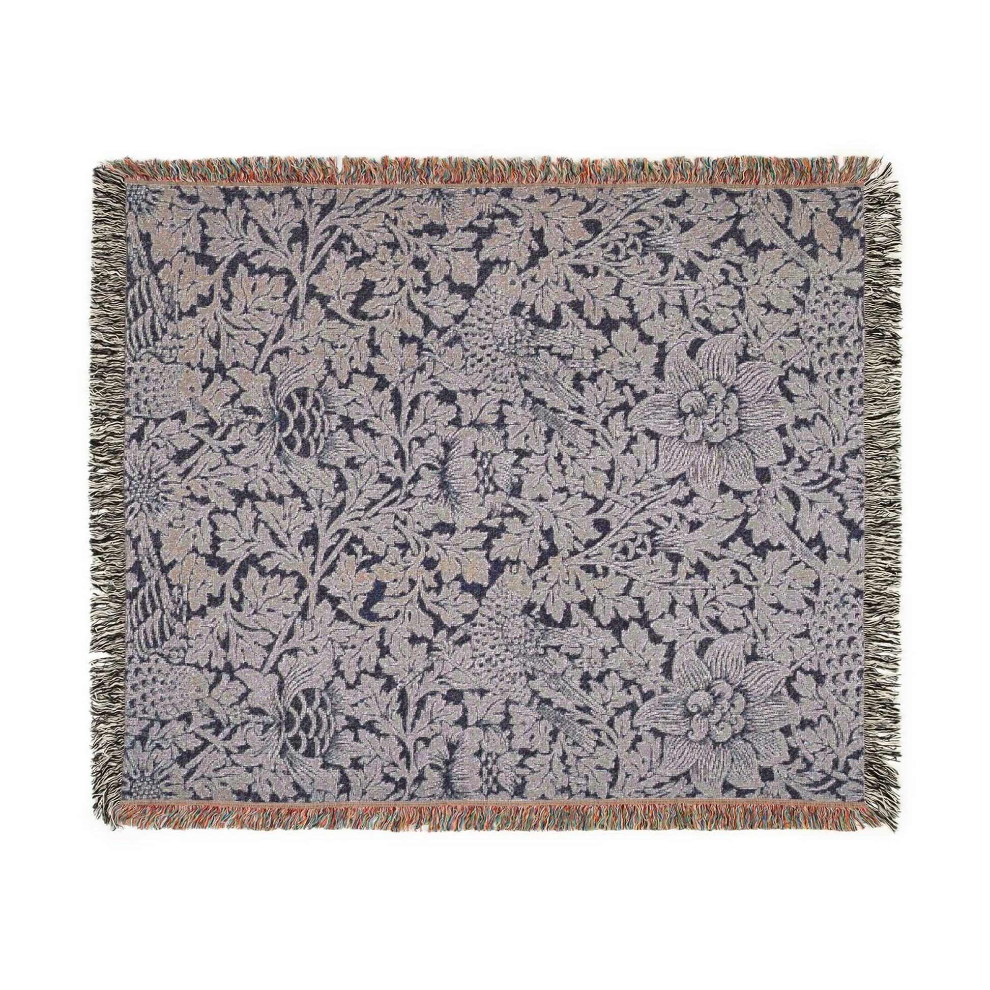 Floral patterned throw blanket with fringe on a white background