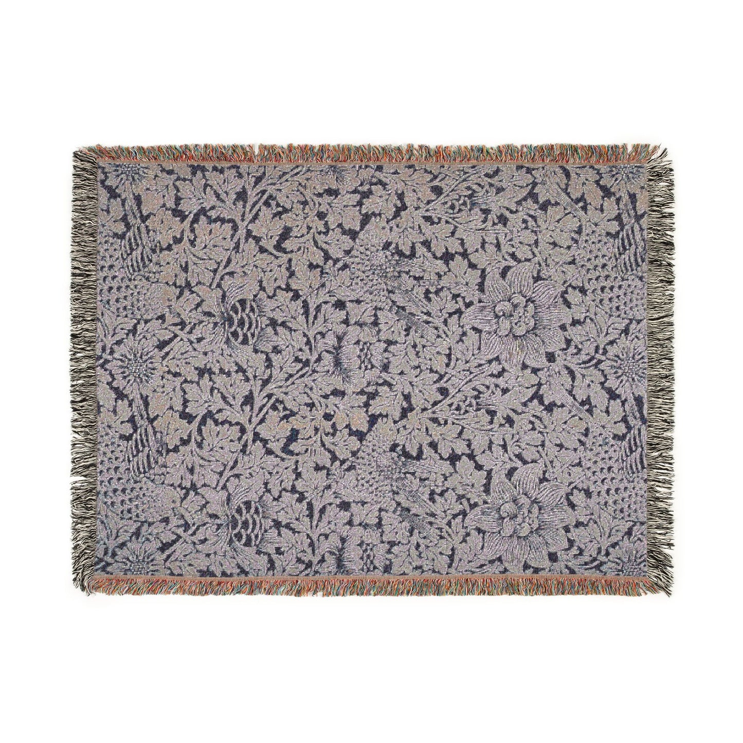 Floral patterned throw blanket with fringe on a white background