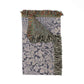Patterned throw blanket with fringes on a white background