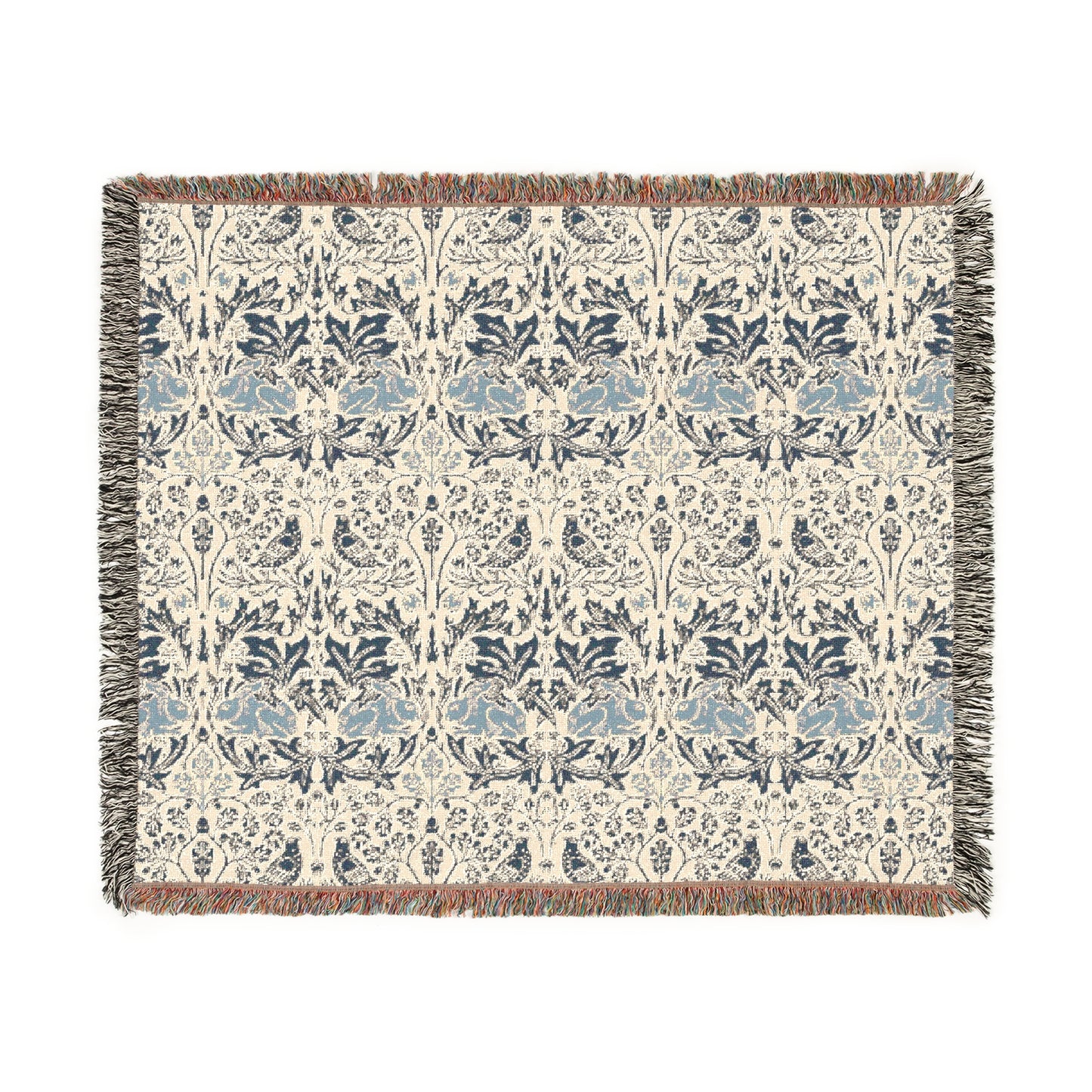A woven cotton blanket with a geometric pattern in gray, blue, and beige colors, featuring fringed edges.