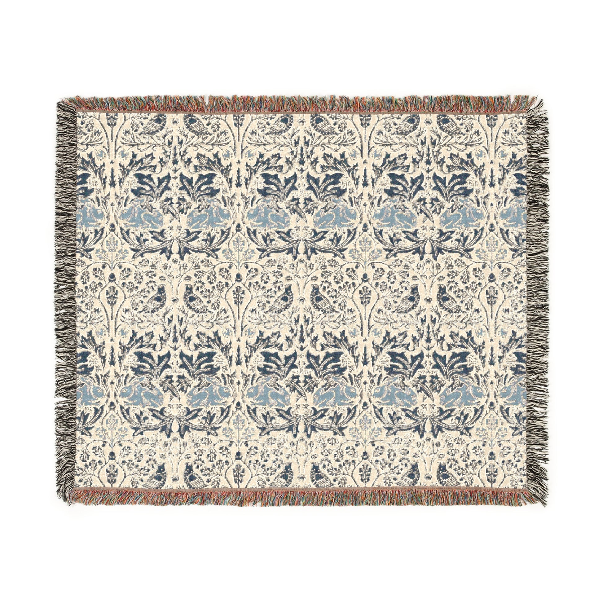 A woven cotton blanket with a geometric pattern in gray, blue, and beige colors, featuring fringed edges.
