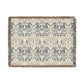 A woven cotton blanket with a geometric pattern in gray, blue, and beige colors, featuring fringed edges.