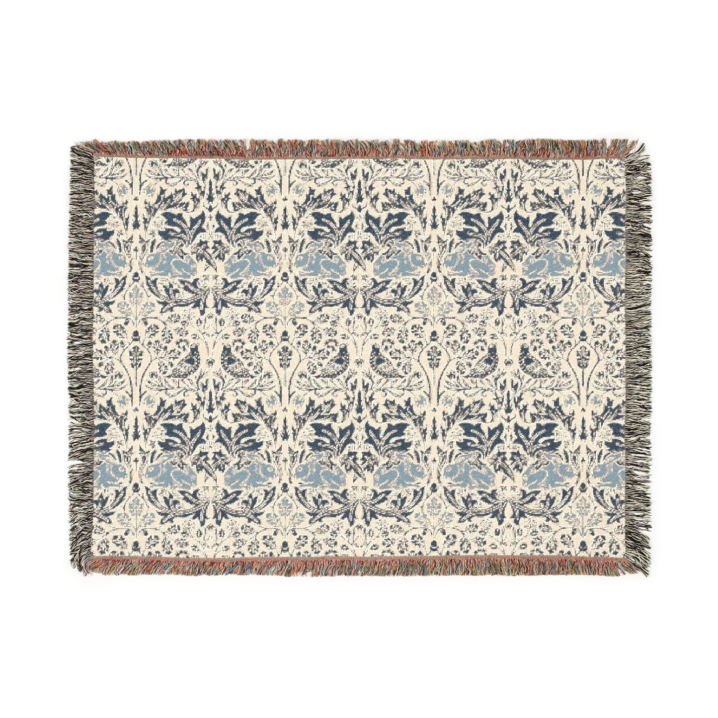 A woven cotton blanket with a geometric pattern in gray, blue, and beige colors, featuring fringed edges.