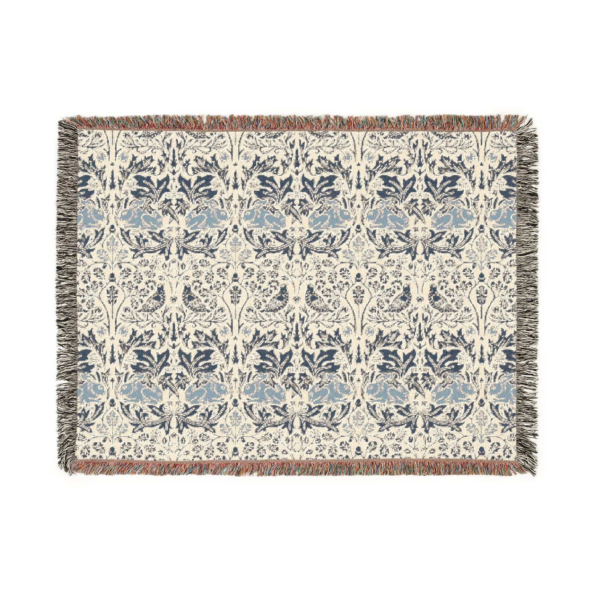 A woven cotton blanket with a geometric pattern in gray, blue, and beige colors, featuring fringed edges.