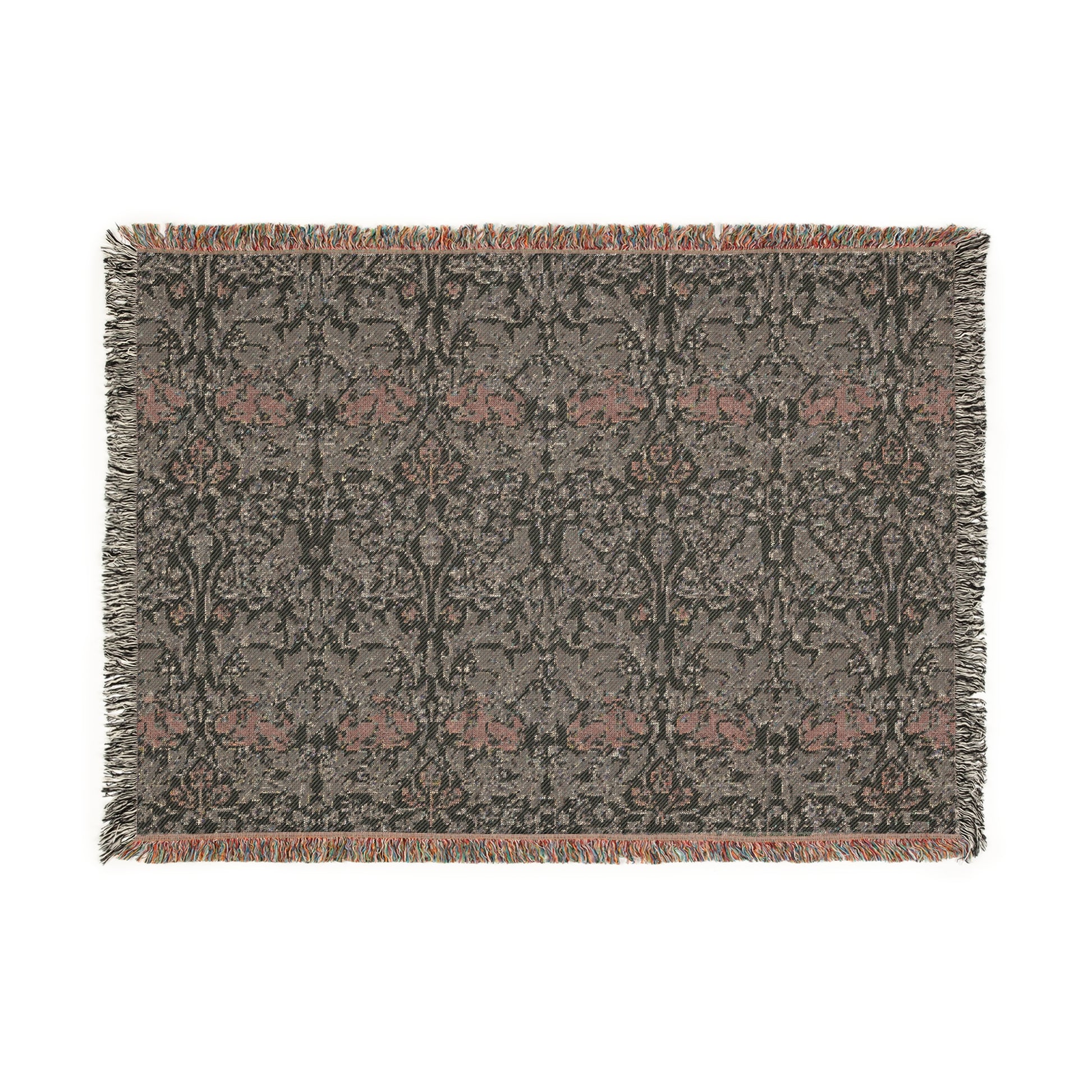 A woven cotton blanket with a geometric William Morris & Co pattern in gray, blue, and beige colours, featuring fringed edges.