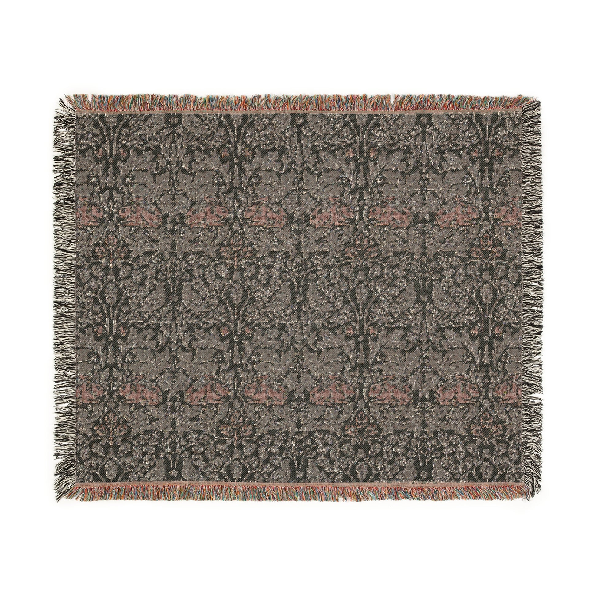 A woven cotton blanket with a geometric William Morris & Co pattern in gray, blue, and beige colours, featuring fringed edges.