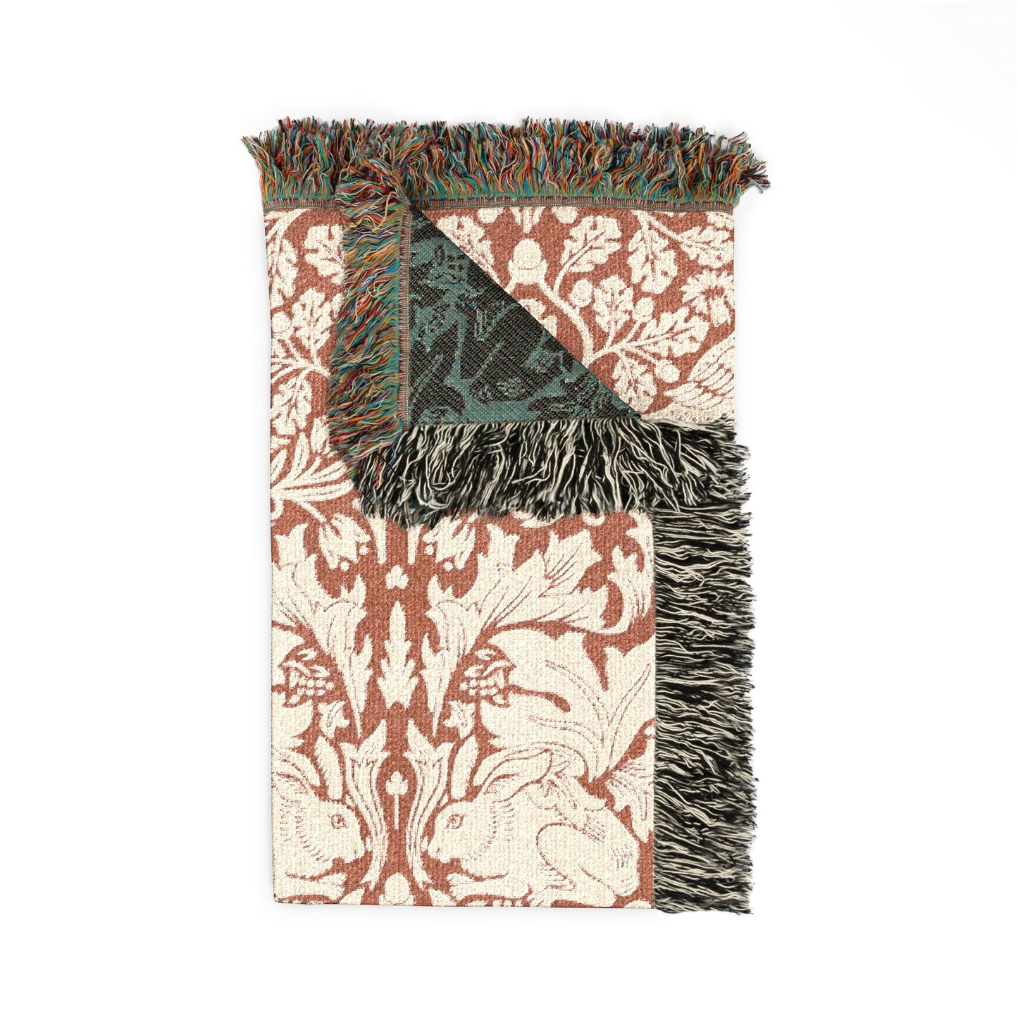 Decorative throw blanket with floral pattern and fringes on a white background