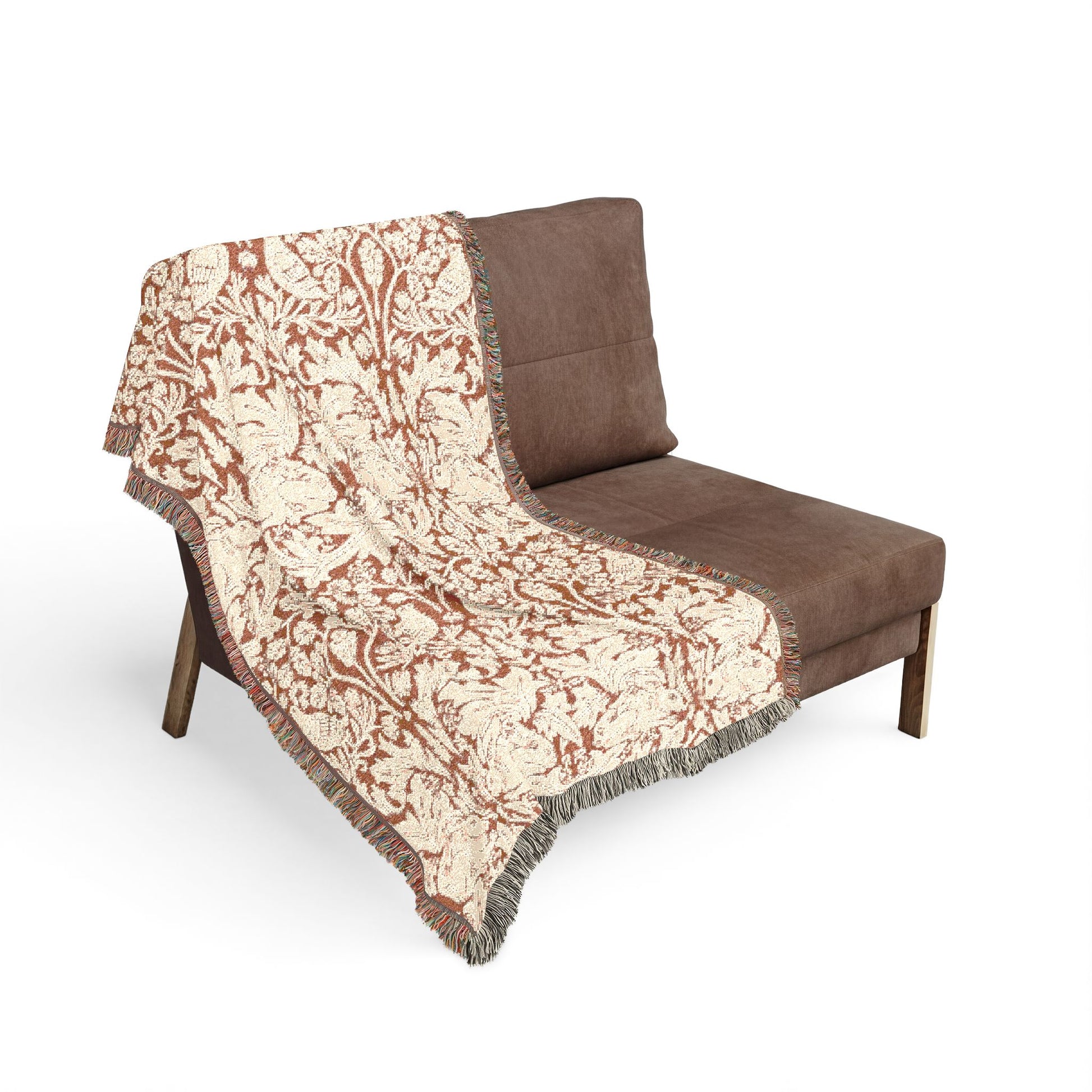 Brown sofa with a patterned beige and brown throw blanket on a white background