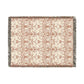 Patterned throw blanket with fringe on a white background