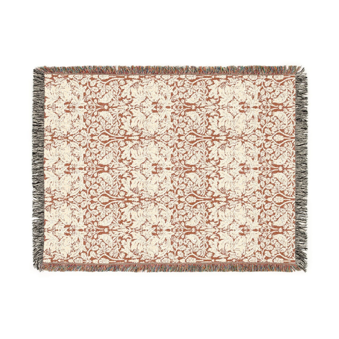 Patterned throw blanket with fringe on a white background