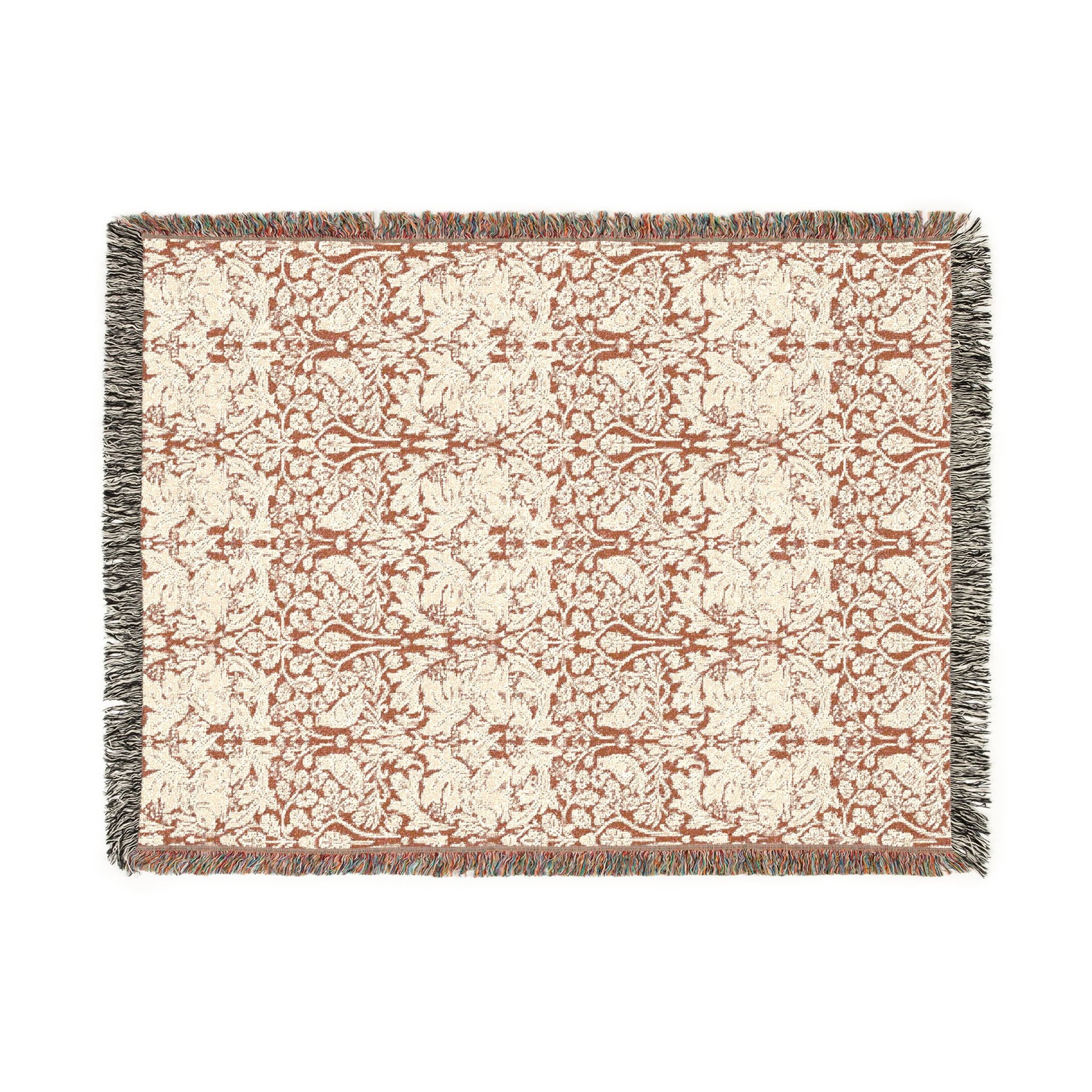 Patterned throw blanket with fringe on a white background