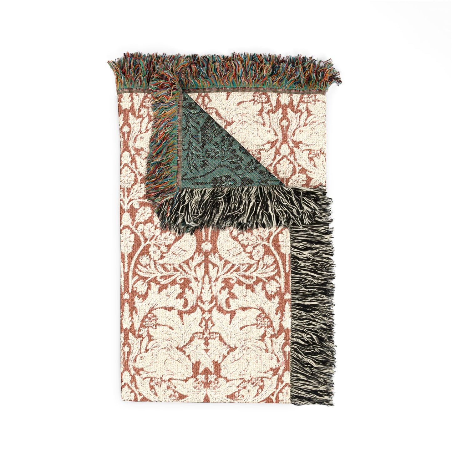 Decorative throw blanket with floral pattern and fringed edges on a white background