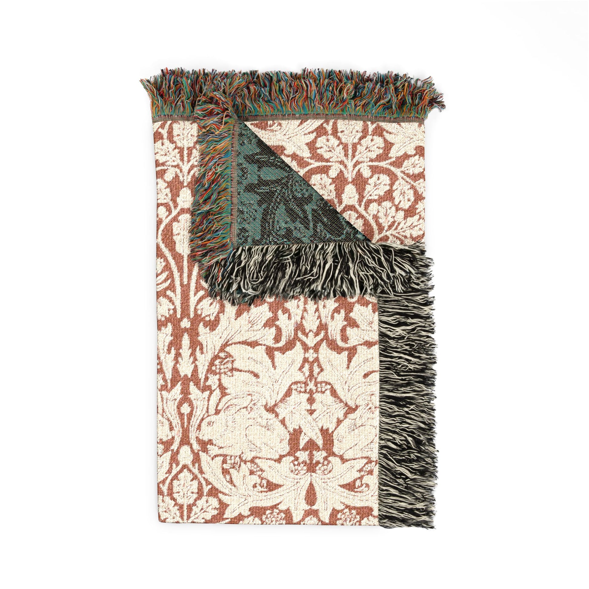 Decorative throw blanket with patterned design and fringes on a white background