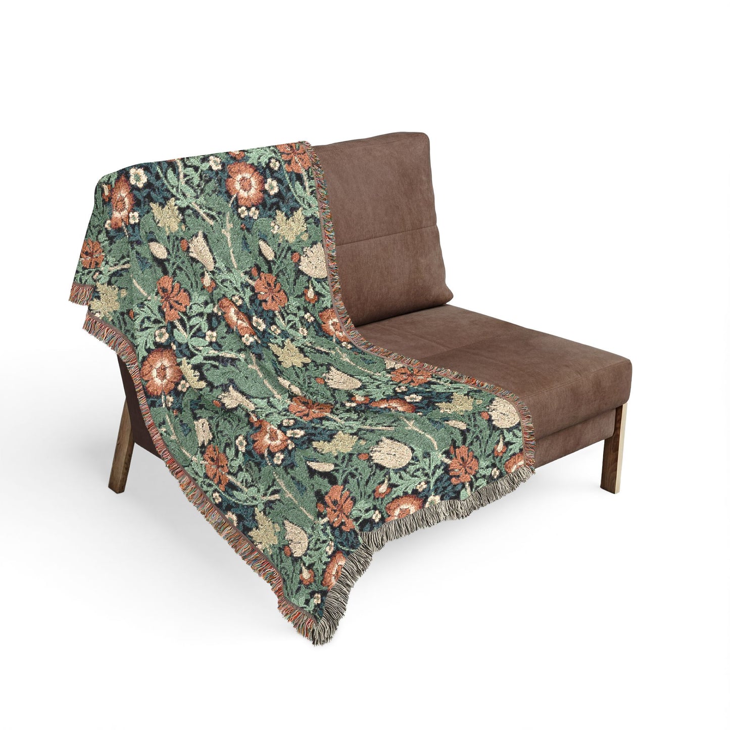Floral patterned throw blanket draped over a brown chair on a white background