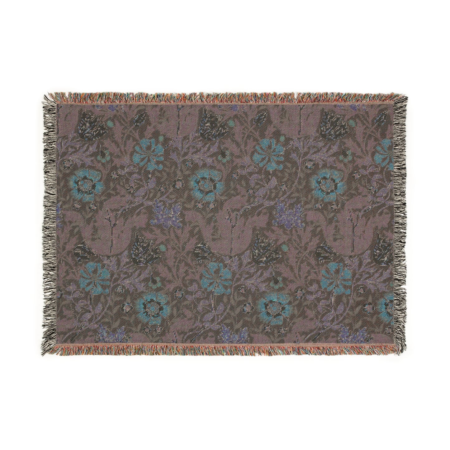 A woven cotton blanket with a William Morris & Co floral pattern in green, brown, and beige colours, featuring colourful fringed edges.