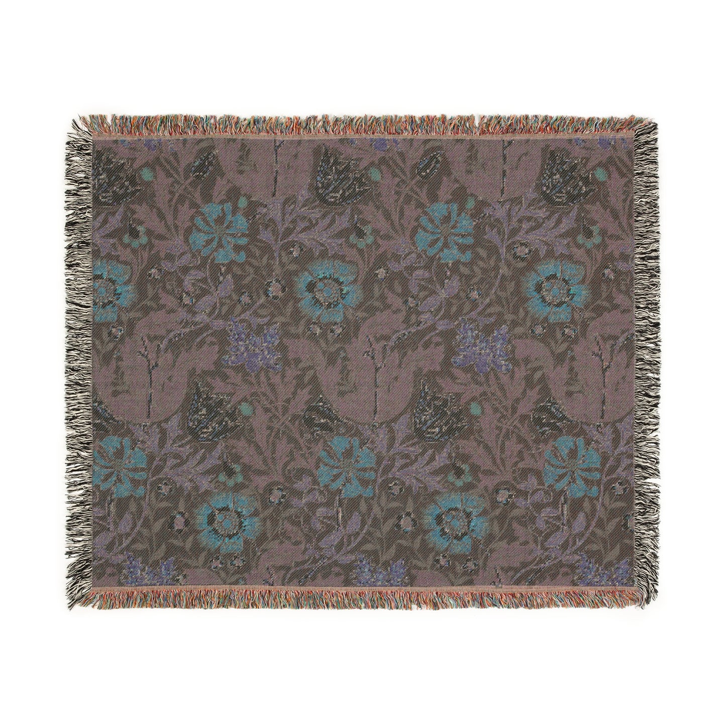 A woven cotton blanket with a William Morris & Co floral pattern in green, brown, and beige colours, featuring colourful fringed edges.
