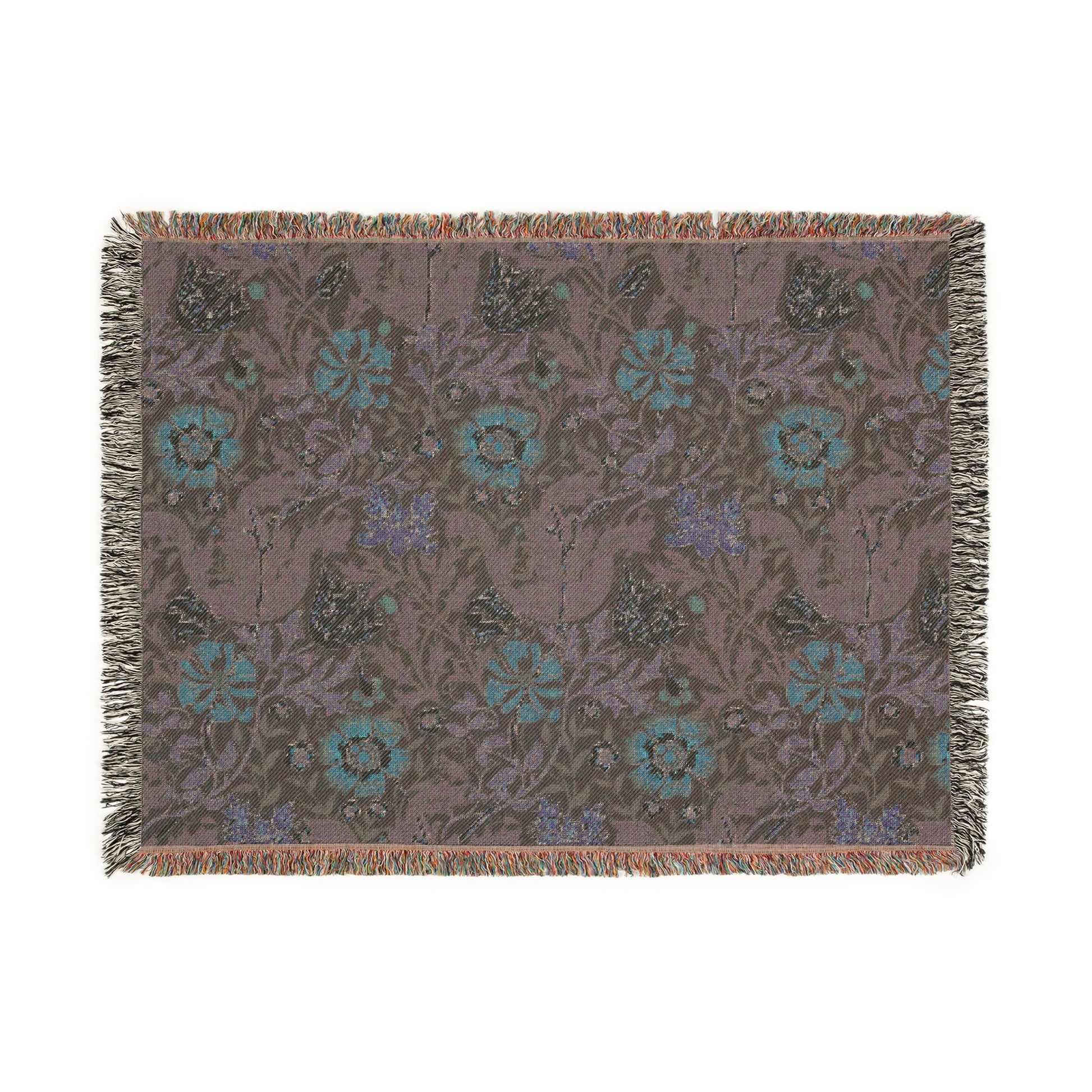 A woven cotton blanket with a William Morris & Co floral pattern in green, brown, and beige colours, featuring colourful fringed edges.