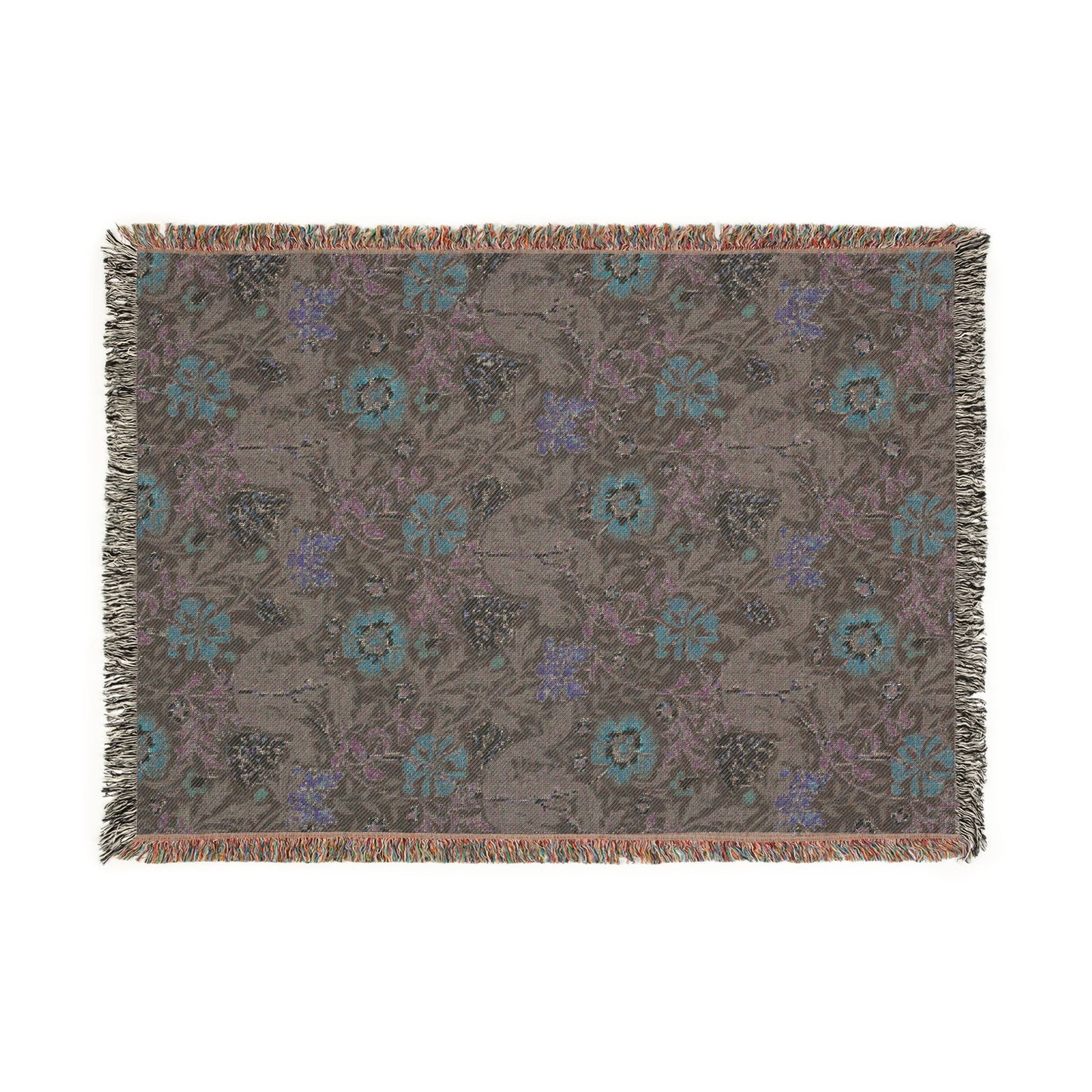 Floral patterned throw blanket with fringe on a white background