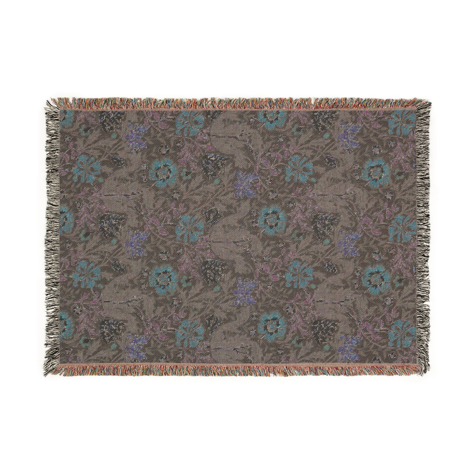 Floral patterned throw blanket with fringe on a white background