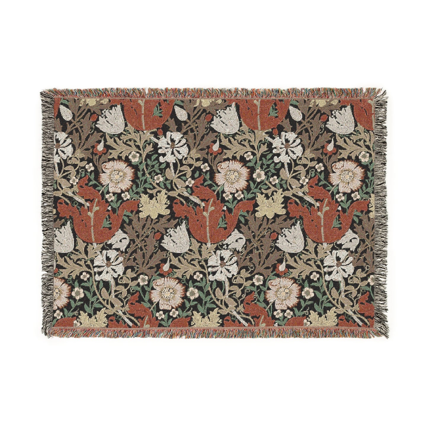 A woven cotton blanket with a geometric and floral pattern in red, green, and beige colors, with fringed edges.