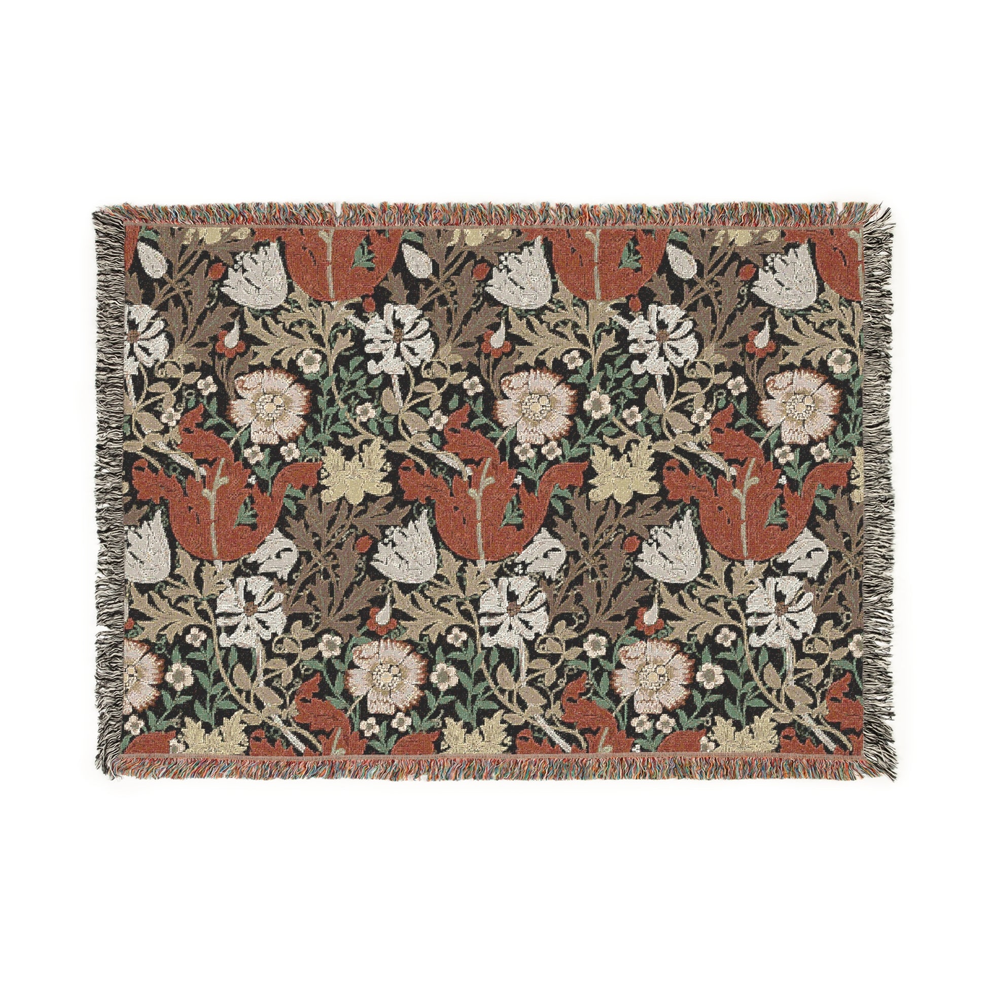 A woven cotton blanket with a geometric and floral pattern in red, green, and beige colors, with fringed edges.