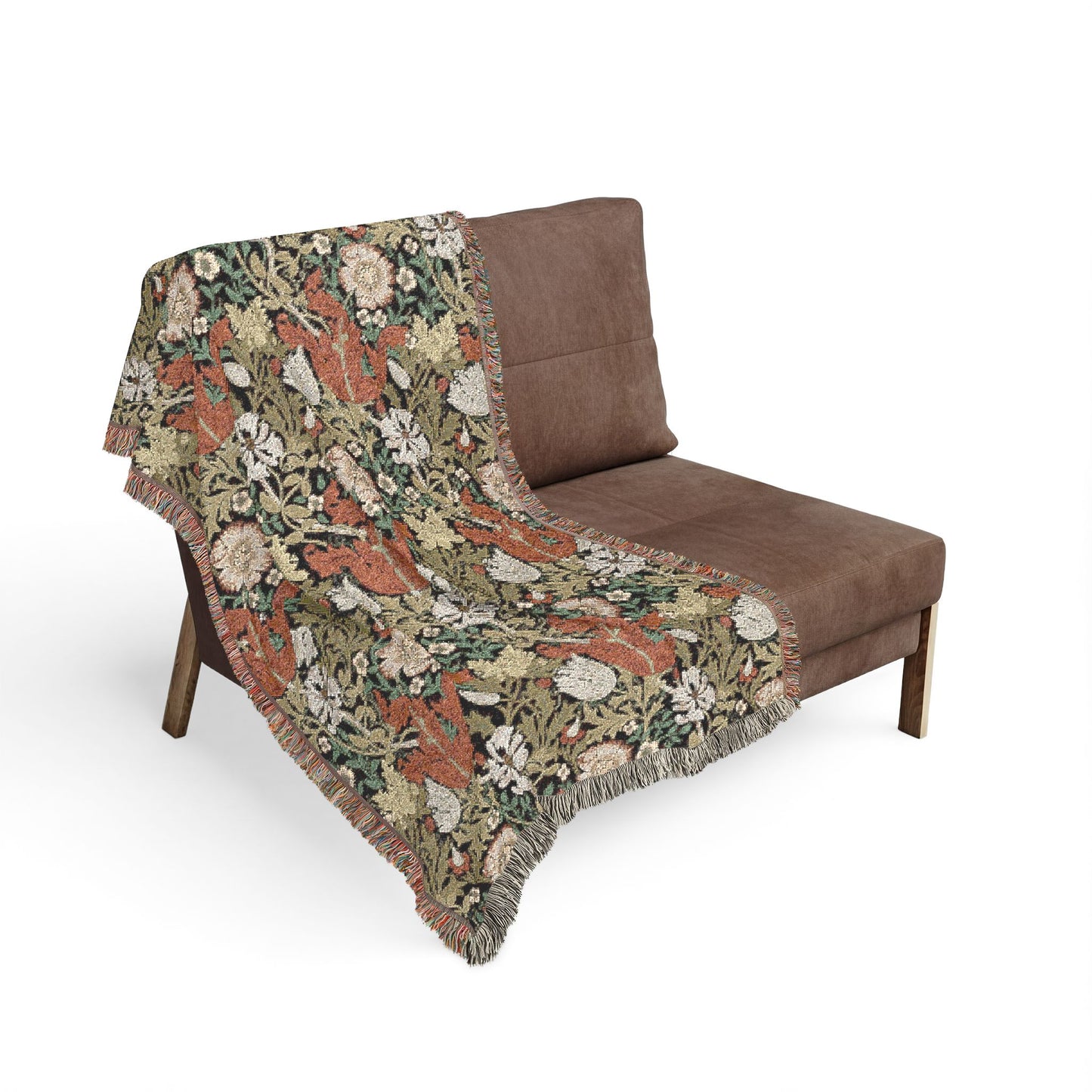 Floral-patterned blanket draped over a brown sofa on a white background