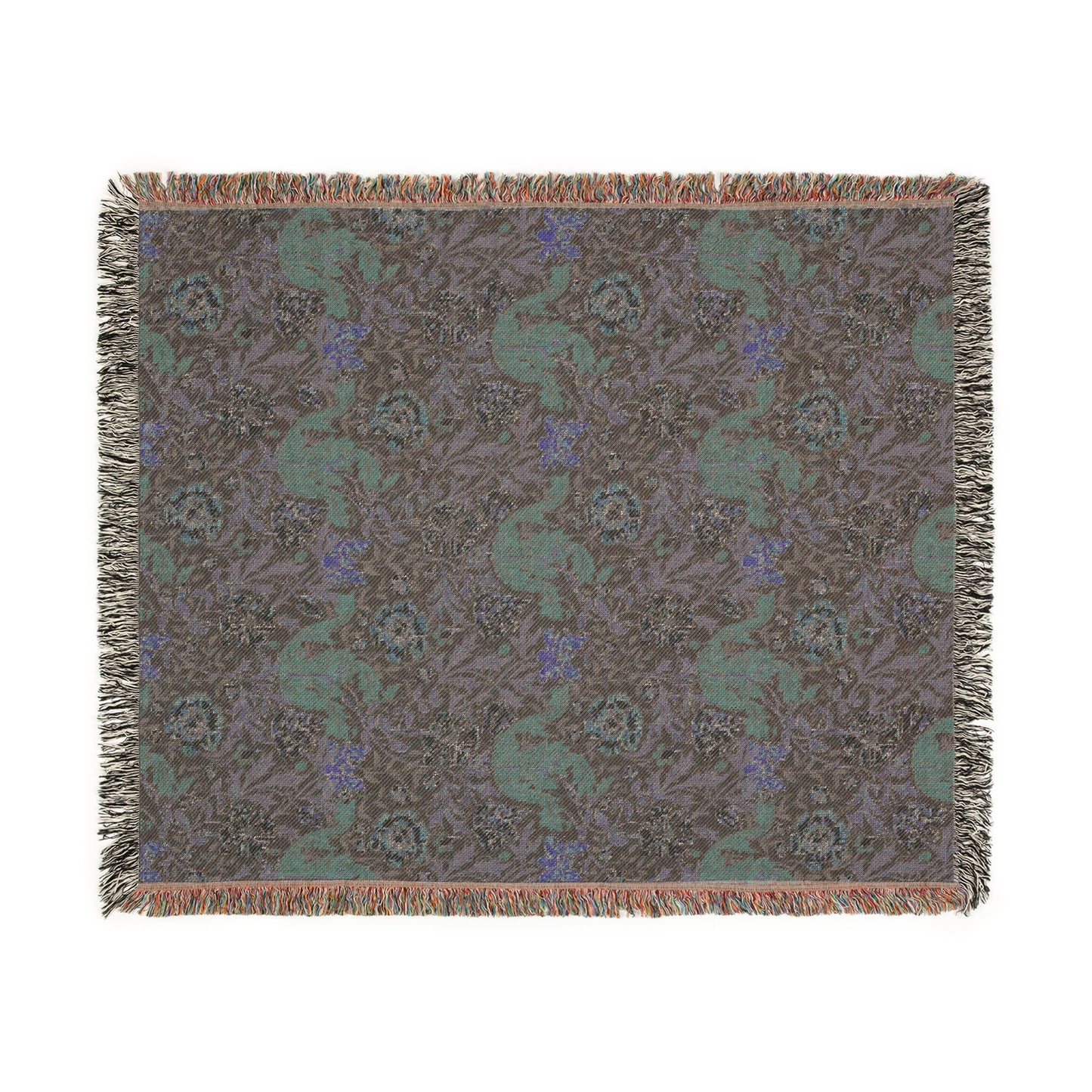 Patterned throw blanket with green and blue design on a brown background