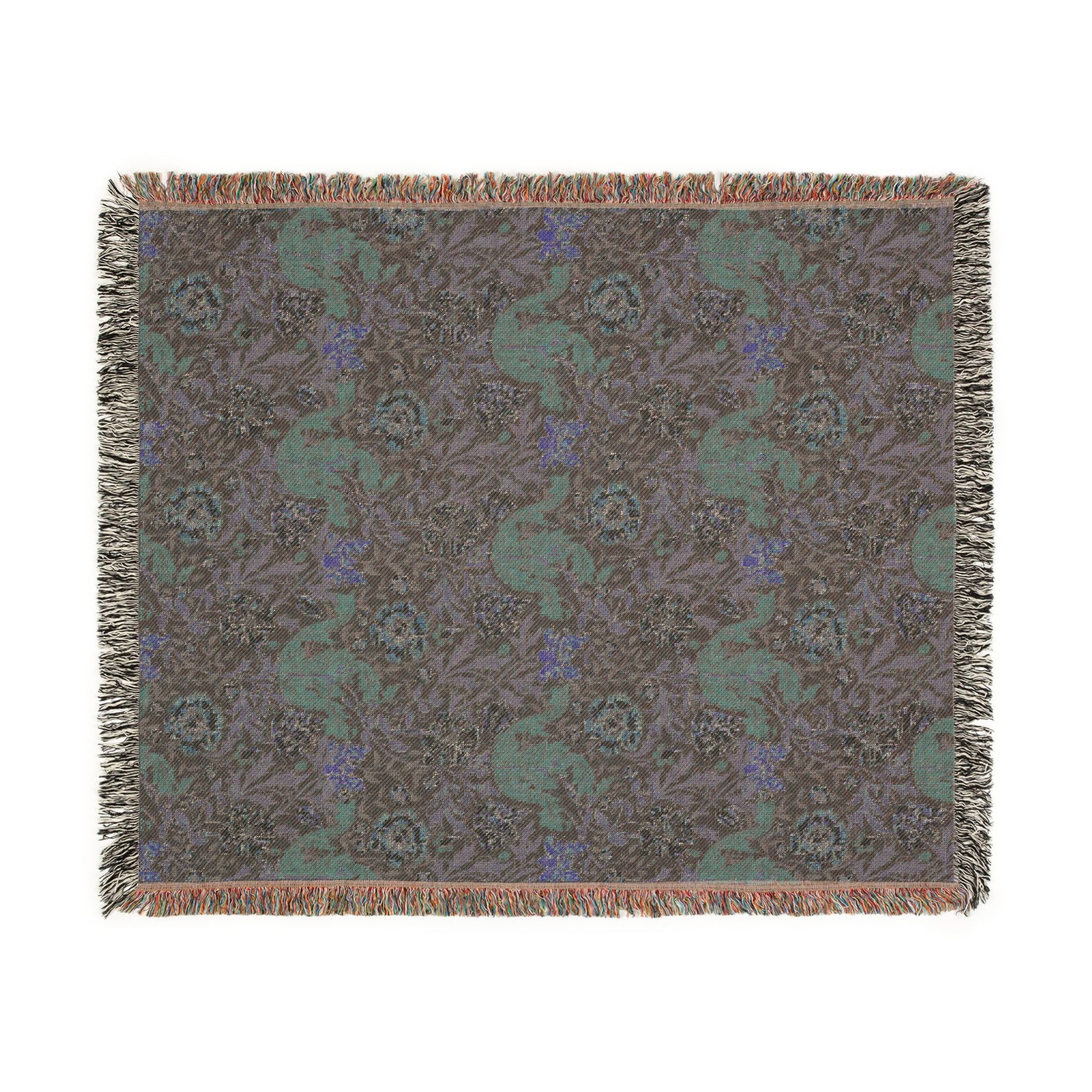 Patterned throw blanket with green and blue design on a brown background