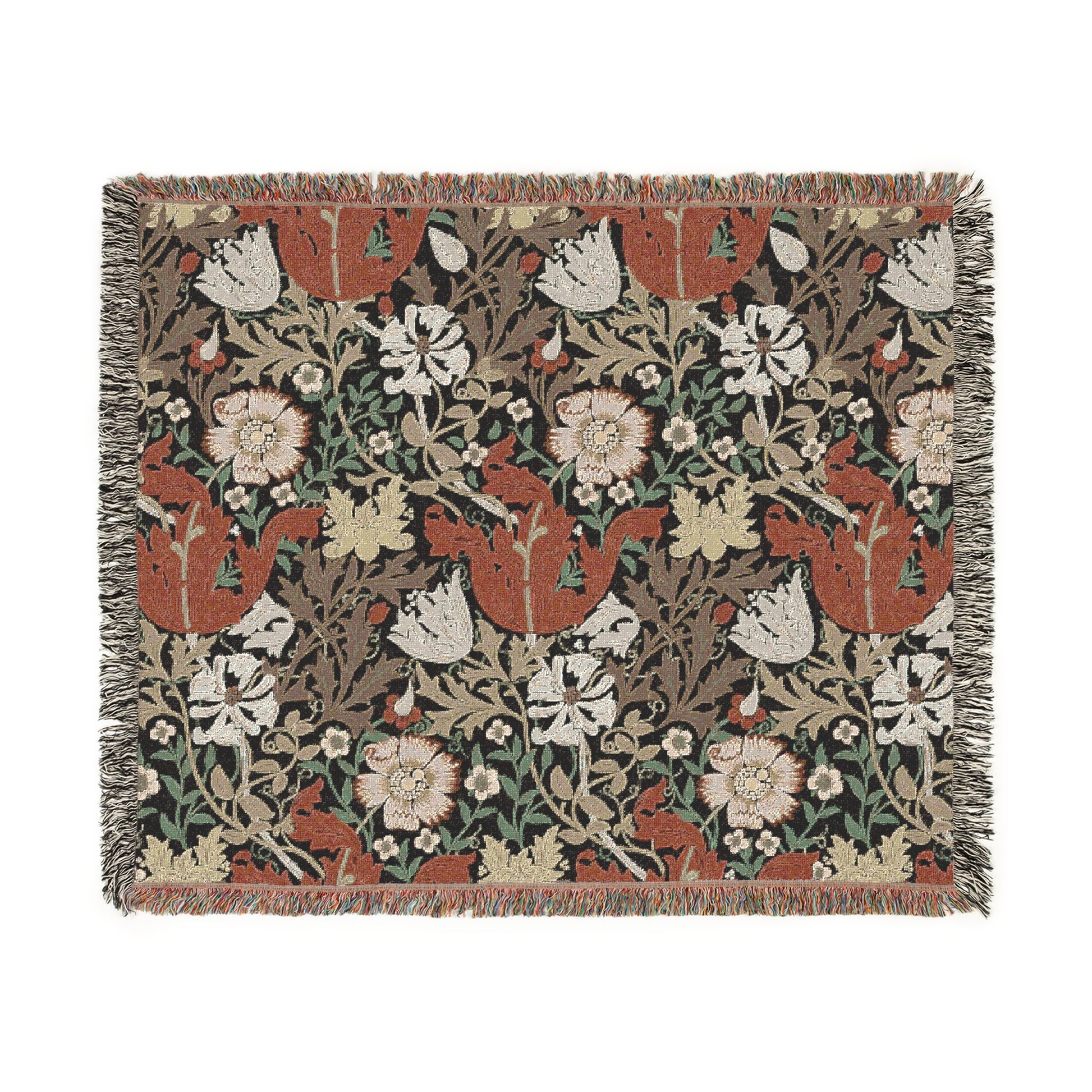 A woven cotton blanket with a geometric and floral pattern in red, green, and beige colors, with fringed edges.