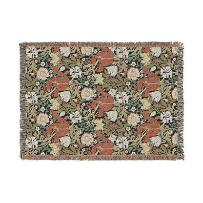 Woven blanket with fox and floral pattern on a white background