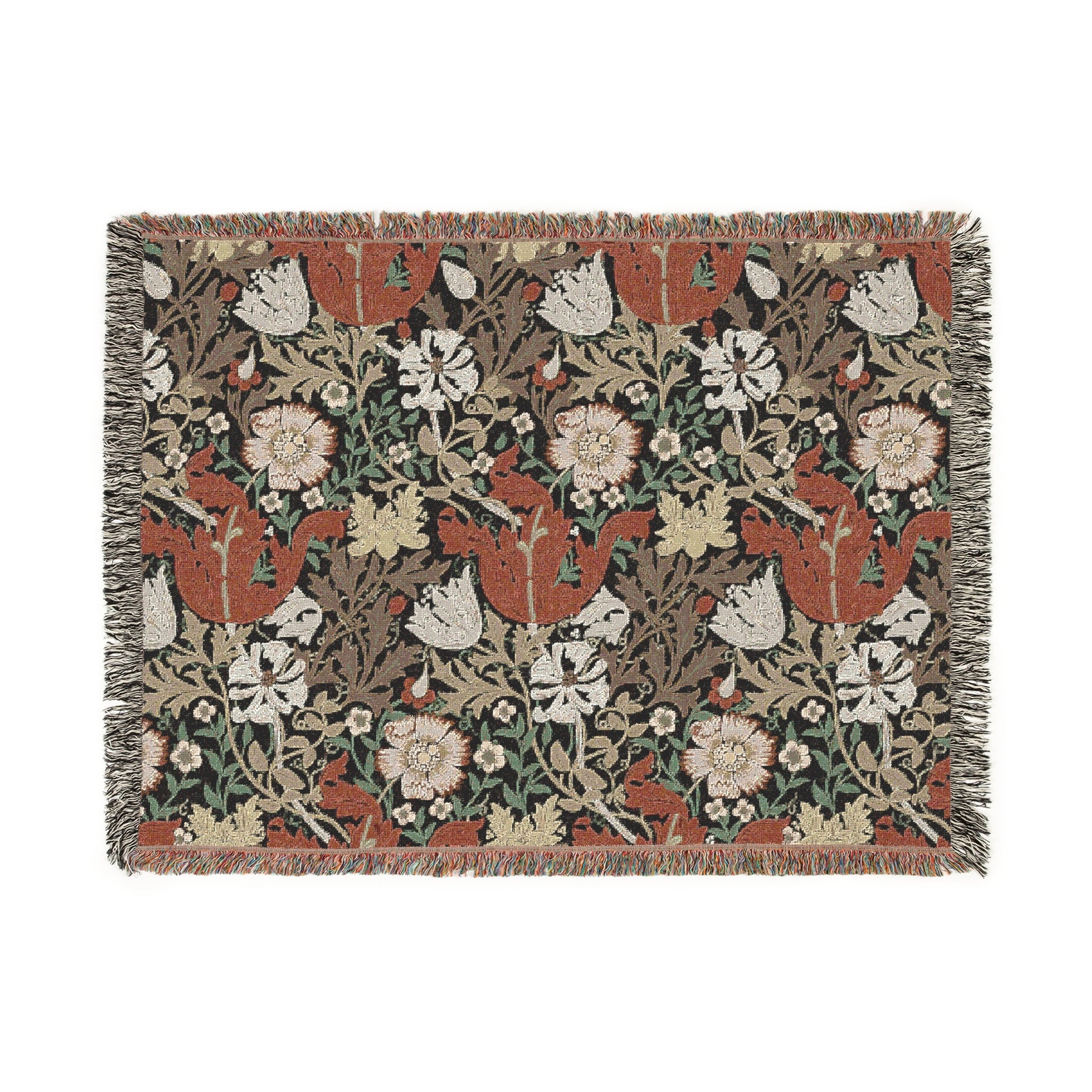 A woven cotton blanket with a geometric and floral pattern in red, green, and beige colors, with fringed edges.