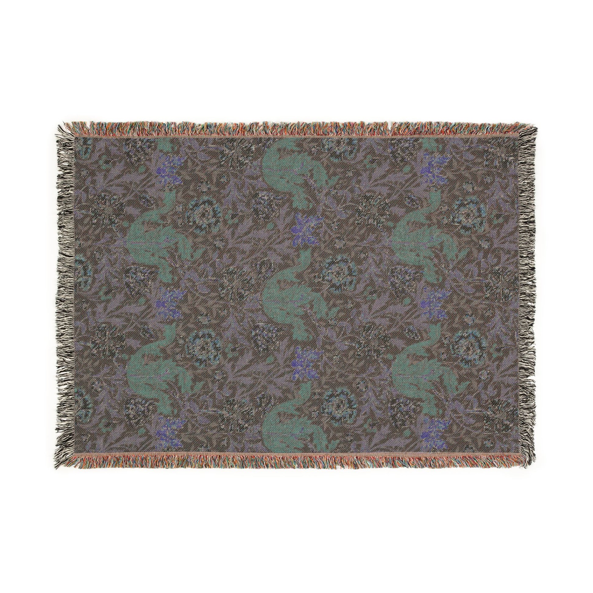 Woven blanket with a pattern of deer and flowers on a plain background