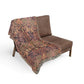 Brown patterned throw blanket draped over a brown chair on a white background
