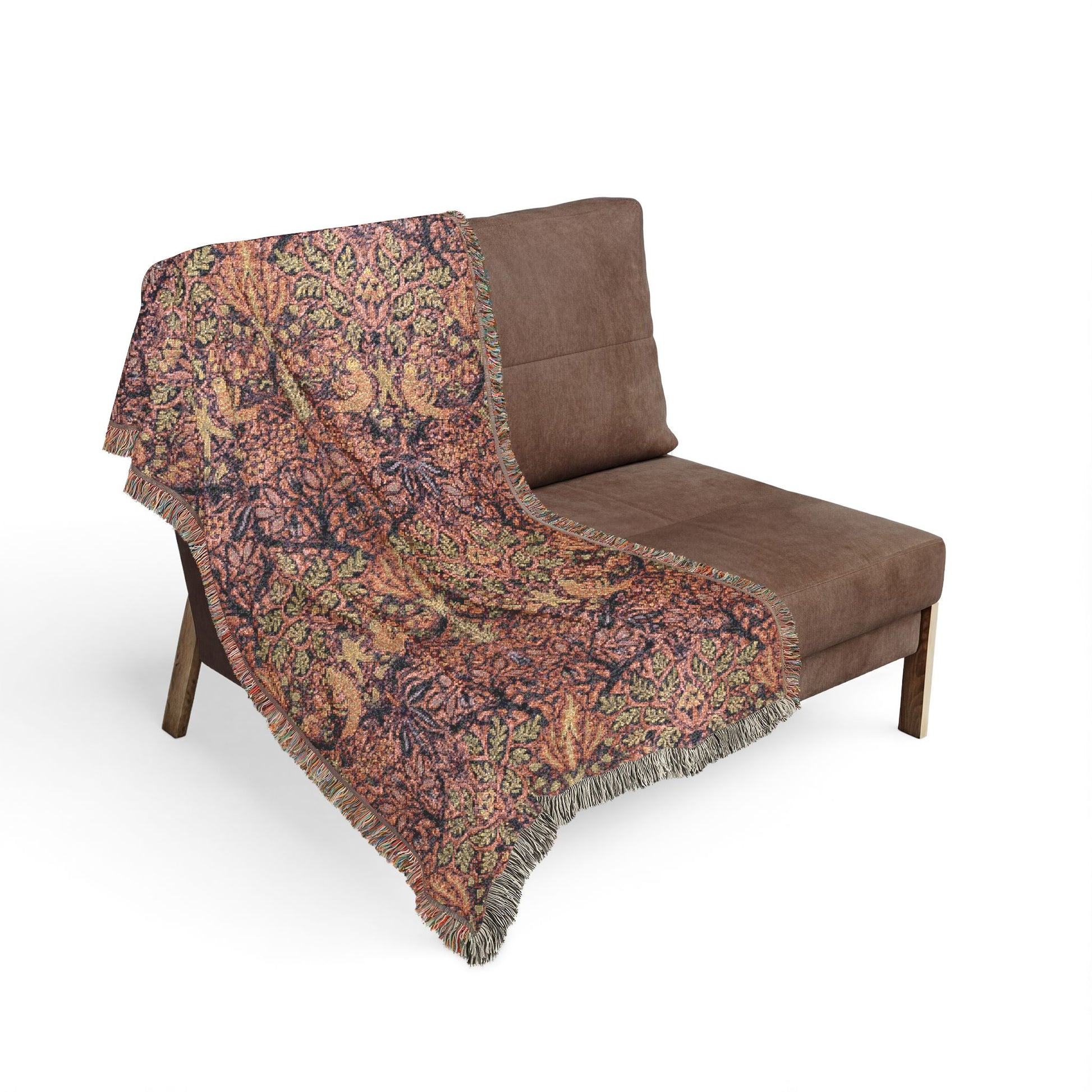 Brown patterned throw blanket draped over a brown chair on a white background