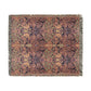 Patterned throw blanket with fringe on a white background