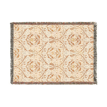 A woven cotton blanket with a geometric Willy Morris & Co pattern in beige, brown, and multicolour, with fringed edges.