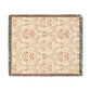 A woven cotton blanket with a geometric pattern in beige, brown, and multicolor, with fringed edges.