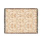A woven cotton blanket with a geometric pattern in beige, brown, and multicolor, with fringed edges.
