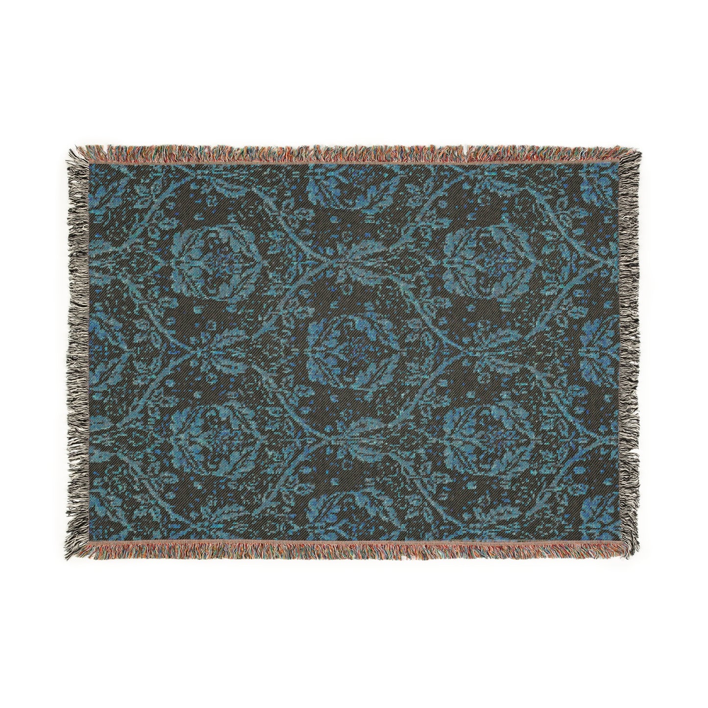 A woven cotton blanket with a geometric Willy Morris & Co pattern in beige, brown, and multicolour, with fringed edges.