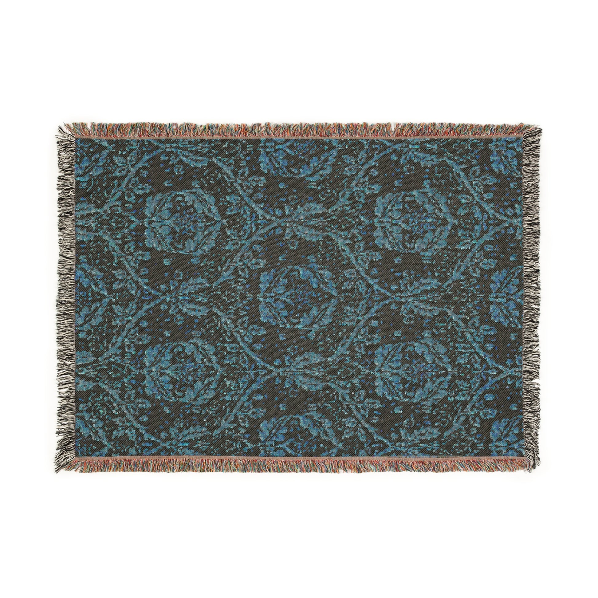 A woven cotton blanket with a geometric Willy Morris & Co pattern in beige, brown, and multicolour, with fringed edges.