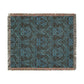 A woven cotton blanket with a geometric Willy Morris & Co pattern in beige, brown, and multicolour, with fringed edges.