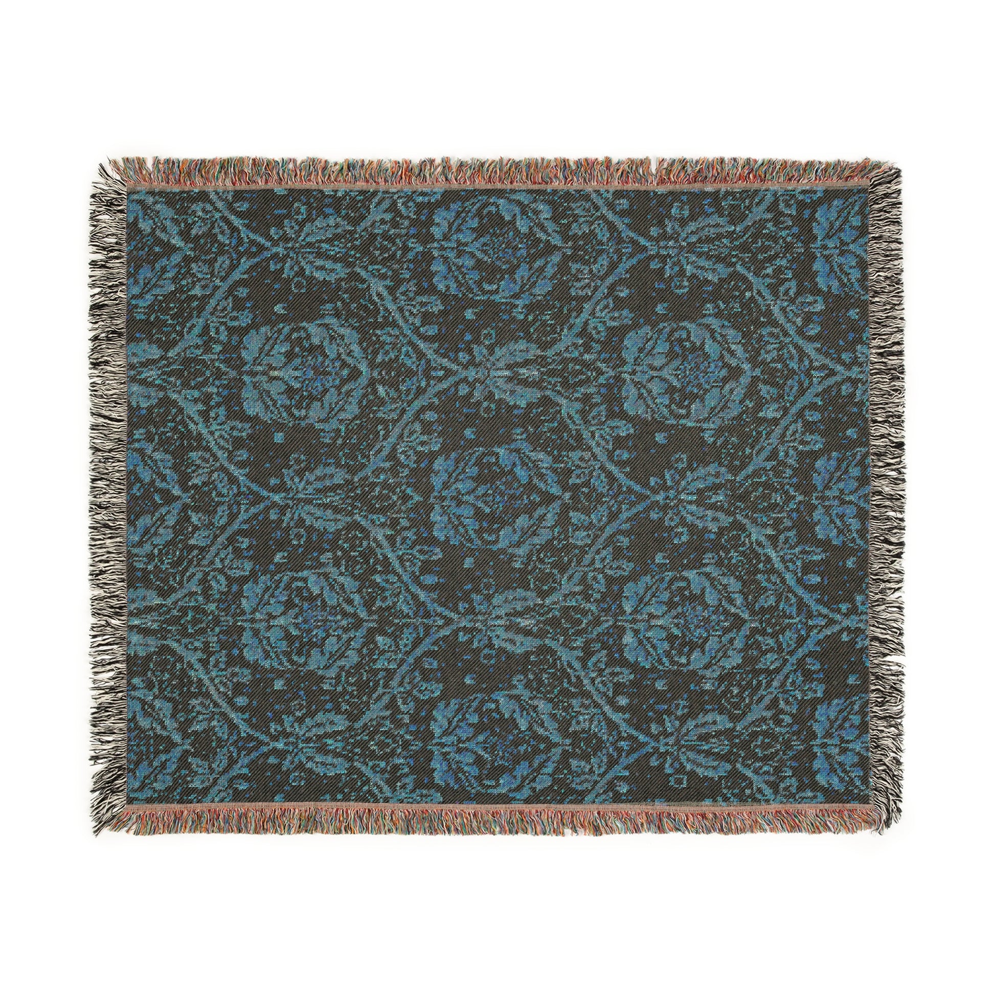 A woven cotton blanket with a geometric Willy Morris & Co pattern in beige, brown, and multicolour, with fringed edges.