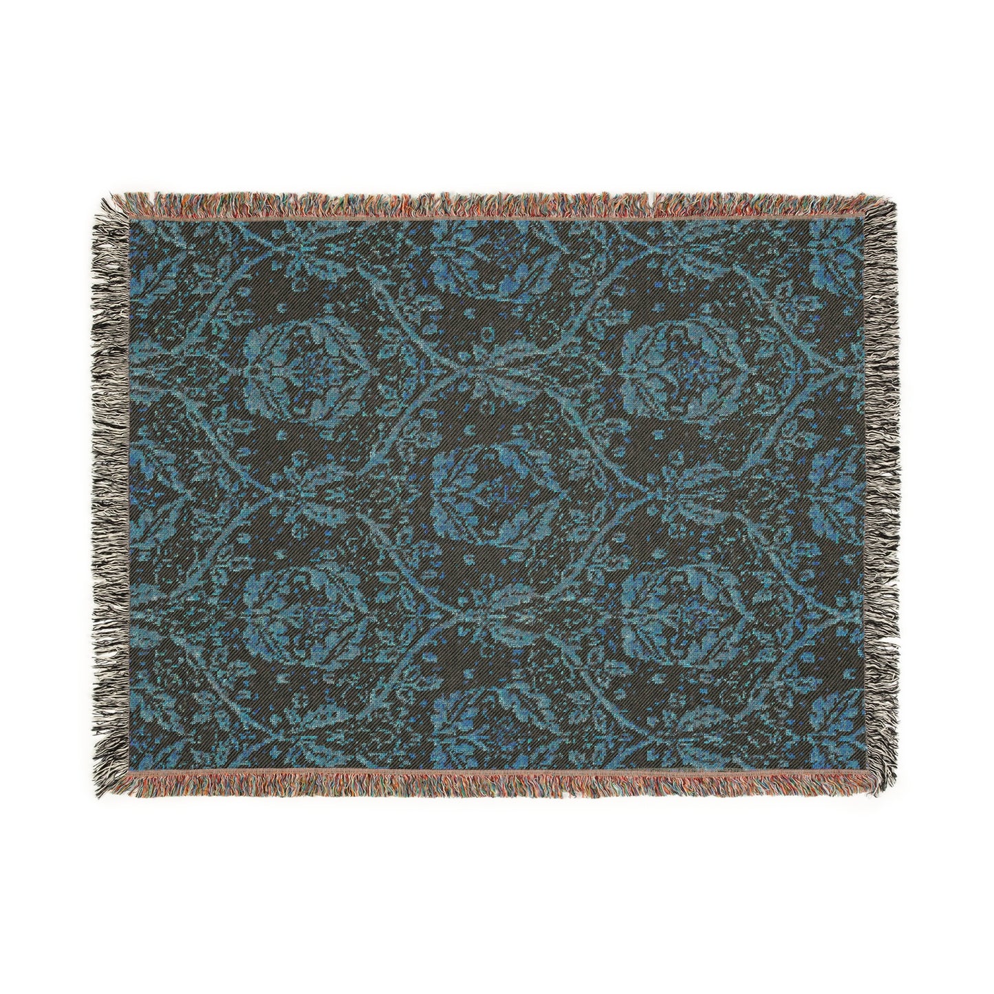 A woven cotton blanket with a geometric Willy Morris & Co pattern in beige, brown, and multicolour, with fringed edges.